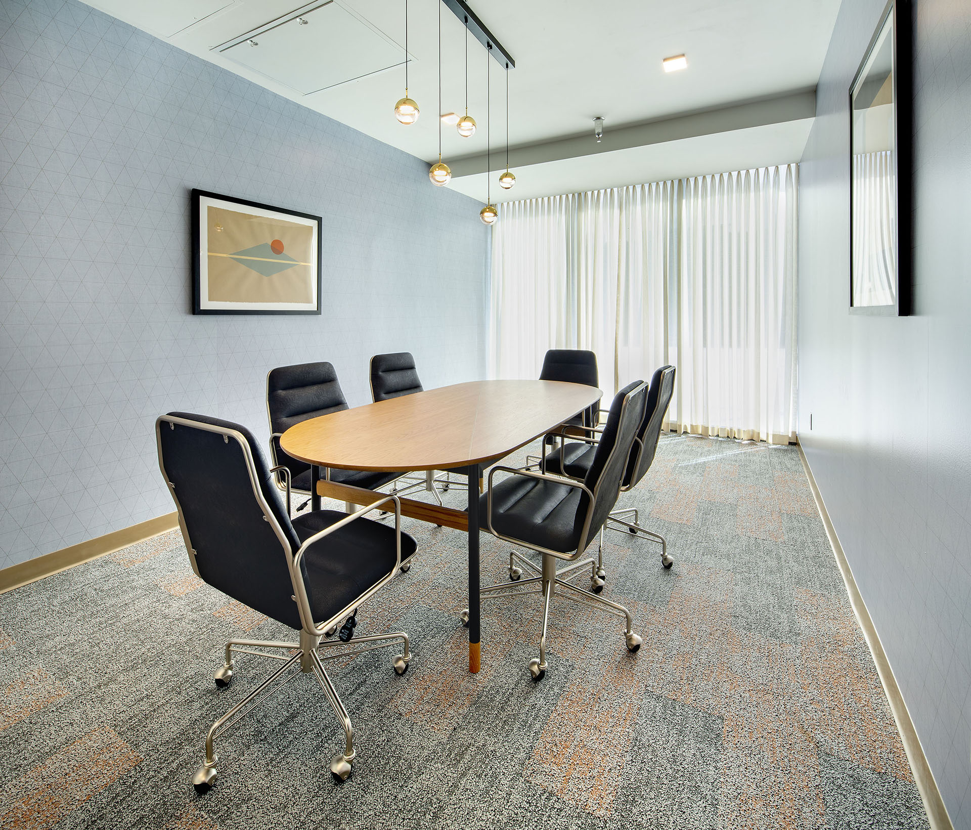 Crosby Apartments resident amenity - Meeting room with conference table. 